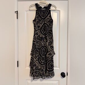 Liz Claiborne Size 6 Sleeveless Long Ruffle Layered Dress. Cream/black print.